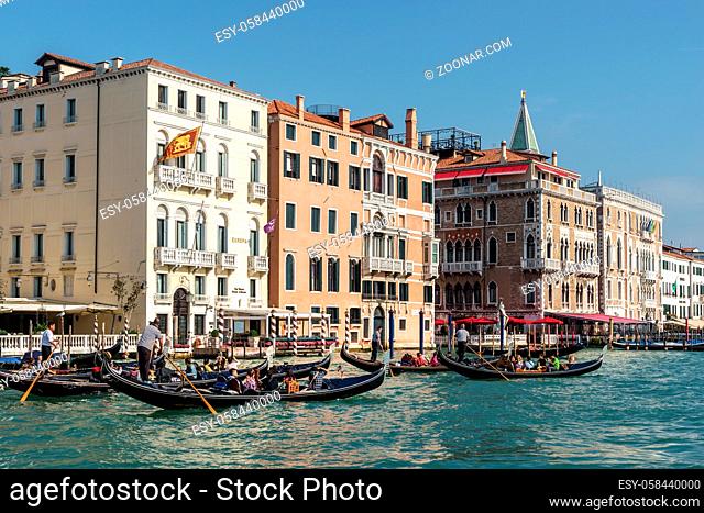 Gondoliers ferrying people in Venice