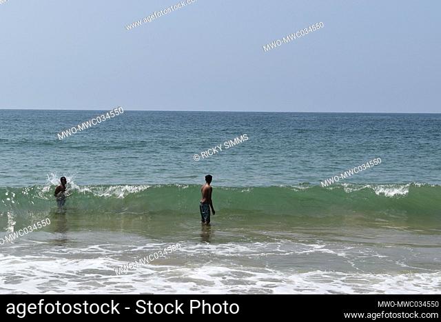 People enjoying the beach on a bright sunny day. Mount Lavinia Beach is the main sea-bathing spot in Colombo. The scenic beach offers a stretch of sand, waves