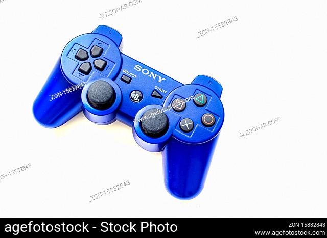 Calgary, Alberta, Canada. July 20, 2020. Blue Sony Play Station control remote on a white background