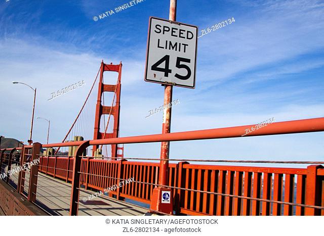 Speed limit 45 sign on the Sidewalk of the Golden gate bridge in San Francisco on a sunny afternoon, blue sky