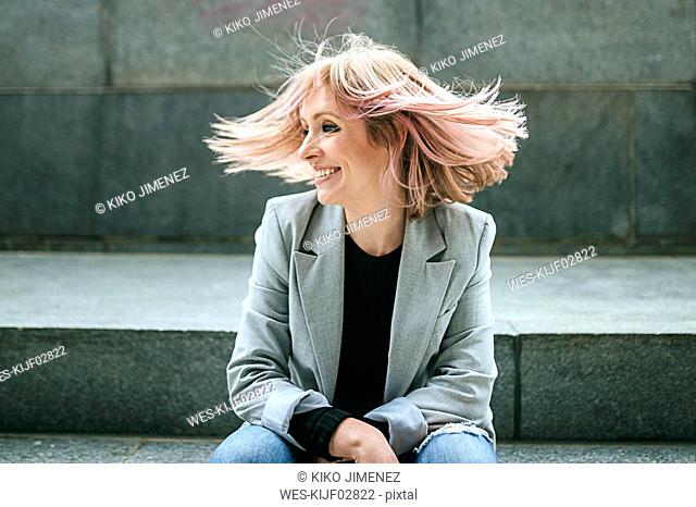 Happy woman moving her pink hair