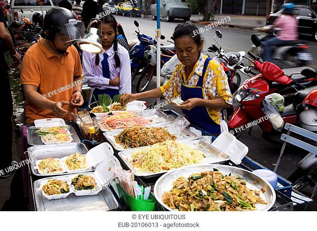 Street vendor sells take away Pad-thai the national fried noodle classic dish