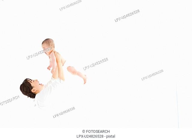 Mother holding up baby boy