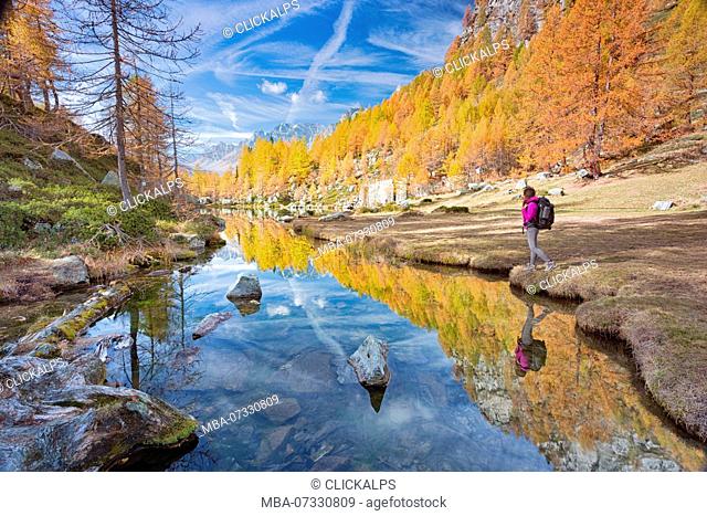 A tourist staring at the small lake near Crampiolo known as Witches Lake, Alpe Veglia and Alpe Devero Natural Park, Baceno, Verbano Cusio Ossola province