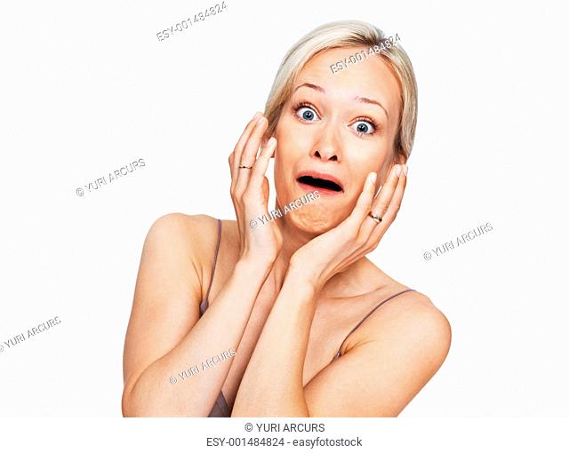 Portrait of beautiful young woman looking frighten on white background