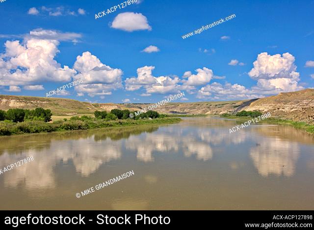 Badlands and clouds reflected in the South Saskatchewan River off Hwy 41 Near Empress Alberta Canada