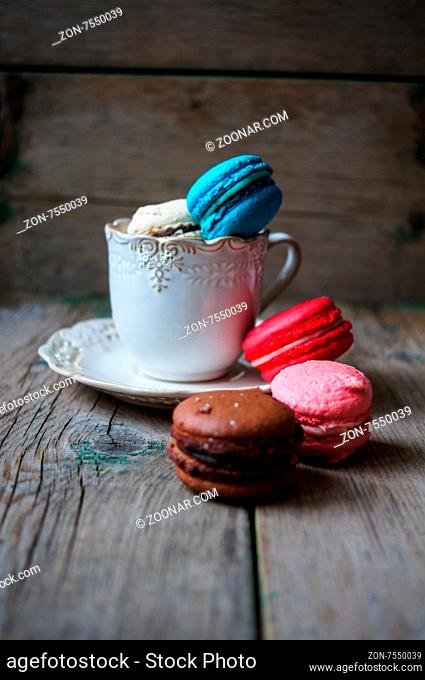 Colorful macaroons on old wooden background