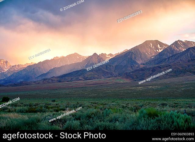 Mountain range with clouded colorful sunset, Eastern Sierra Nevada Mountains, Mono County, California, USA