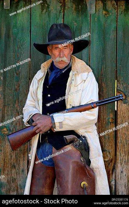 Portrait of Cowboy with Rifle, Shell, Wyoming, USA