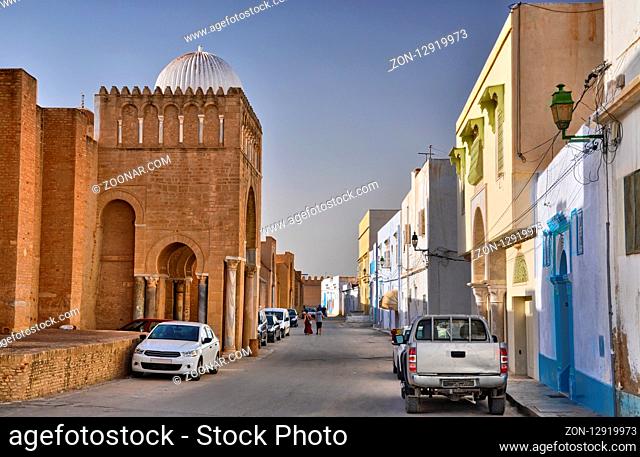 Autos near ancient Great Mosque in Kairouan, Sahara Desert, Tunisia, Africa, HDR