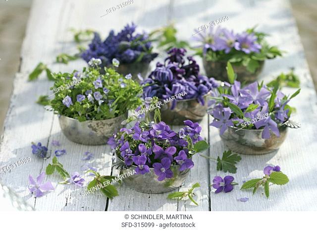 Silver bowls filled with various blue & purple flowers