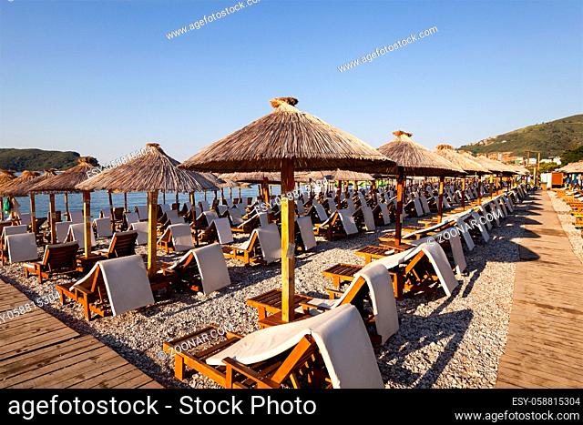 the photographed wooden umbrellas located in the territory of a beach