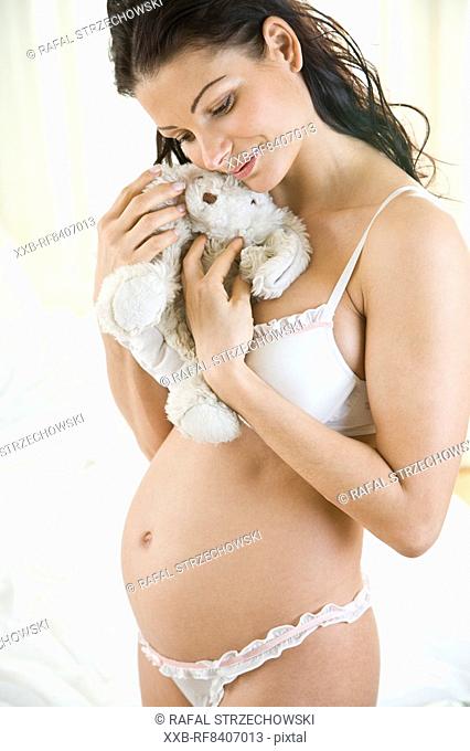 pregnant woman with teddy bear