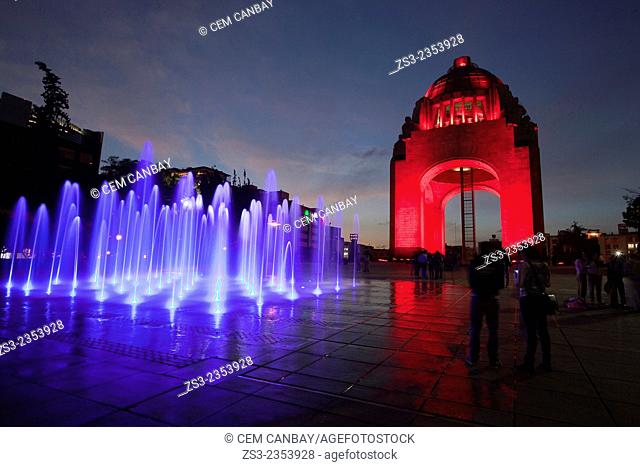Monument dedicated to the Mexican Revolution (Monumento dedicado a la Revoluci—n Mexicana) with colorful water show and silhouettes of people at night