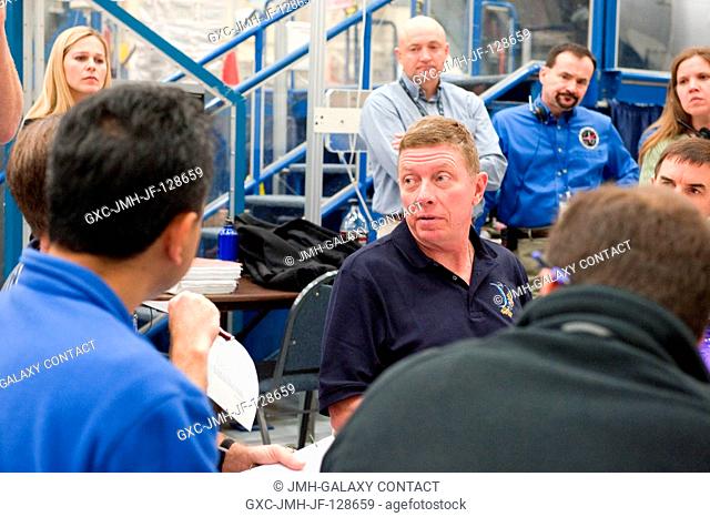 NASA astronaut Mike Fossum (facing camera), Expedition 28 flight engineer and Expedition 29 commander, participates in an emergency scenarios training session...