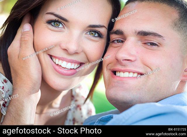 Happy romantic caucasian couple portrait in the park