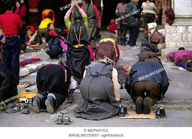 Devout Buddhists prostrate in front of the Jokhnag, Tibet's holiest temple, built in the 7th Century by King Songtsen Gampo, China, Tibet, Lhasa