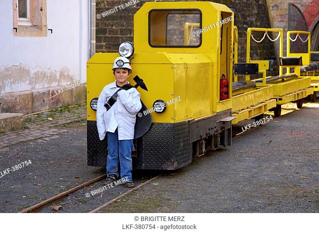 Child in front of the Rischbachstollen, former coalmine that's open to the public, St. Ingbert, Saarland, Germany, Europe