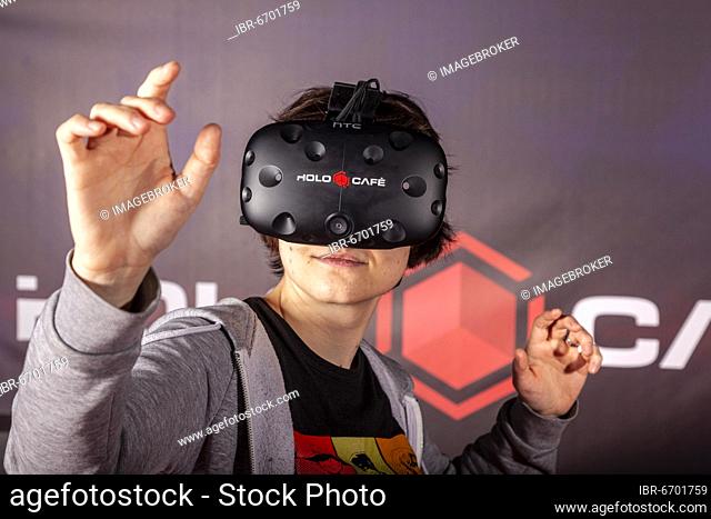 Teenagers with video glasses, virtual reality, multiplayer games for 3D experience, Germany, Europe