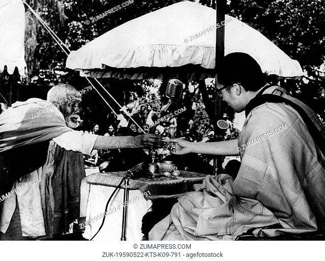 May 22, 1959 - Mussoorie, India - Tibetan spiritual leader TENZIN GYATSO is the 14th and current DALAI LAMA. PICTURED: The Dalai Lama gets a humble offering of...