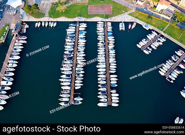 Aerial bird eye view of sailboats and yachts moored in Lovere port, Iseo lake near Bergamo, Italy