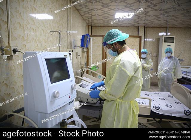 11 June 2020, Syria, Idlib: A doctor wearing full protective gear, checks medical equipment at the first specialized hospital for coronavirus cases in northern...