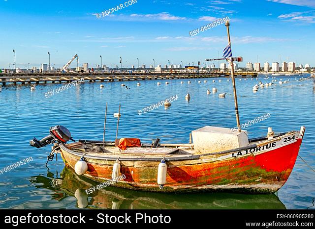 PUNTA DEL ESTE, URUGUAY, OCTOBER - 2018 - Old small fishing boat parked at port in punta del este city, Uruguay
