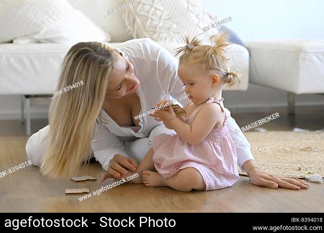 Mother playing with girl, toddler, 11 months, on the floor, toys, Baden-Württemberg, Germany, Europe