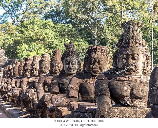 Detail of the stone faces on the bridge at the south gate of Angkor Thom, Angkor Temples complex, Cambodia, Asia