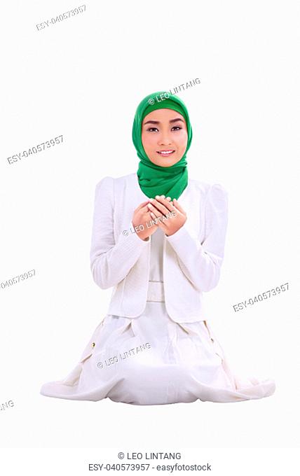 Portrait of asian muslim woman praying isolated over white background