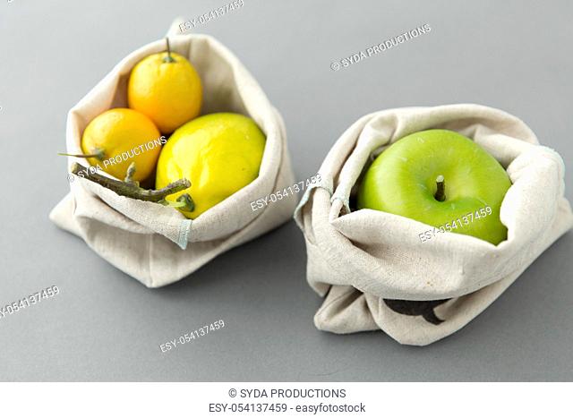 fruits in reusable canvas bags for food shopping