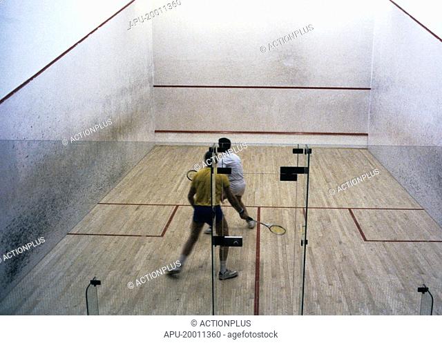 Two men playing racquetball