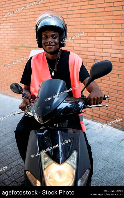 Happy delivery man on motorbike