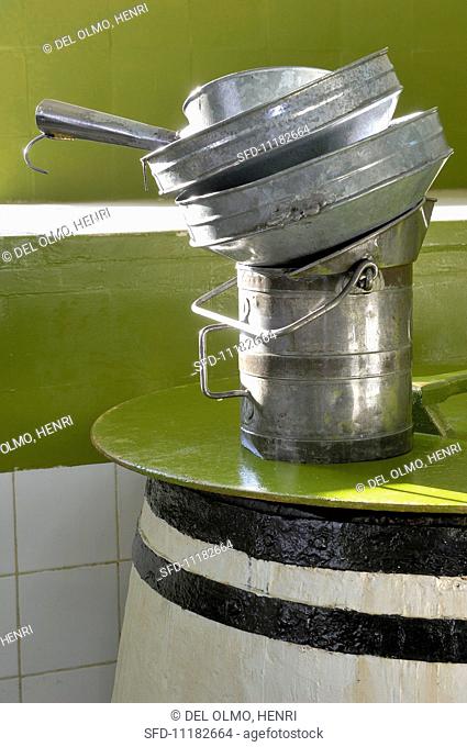A measure and funnels on top of a cask of olive oil (Tunisia)