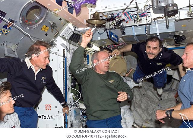 Expedition 13 and STS-115 crew members reunite onboard the International Space Station soon after its docking with the Space Shuttle Atlantis