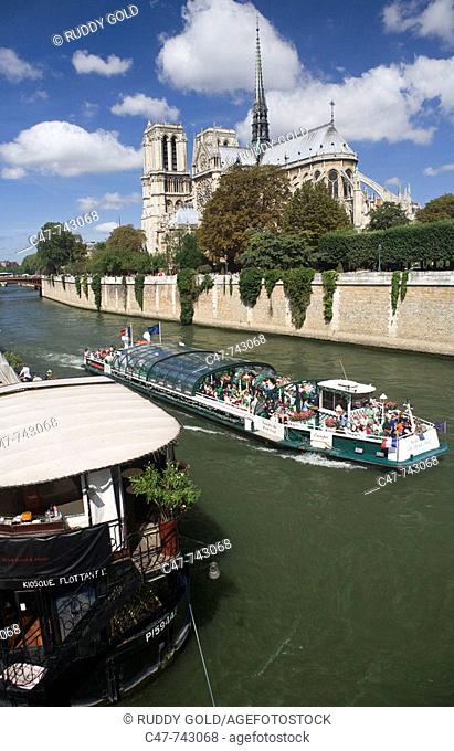 Tourist boat and Notre Dame cathedral. Paris. France