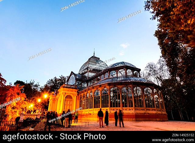 Madrid, Spain - November 10, 2019: The Glass Palace in Buen Retiro Park in Madrid. View at sunset in autumn time