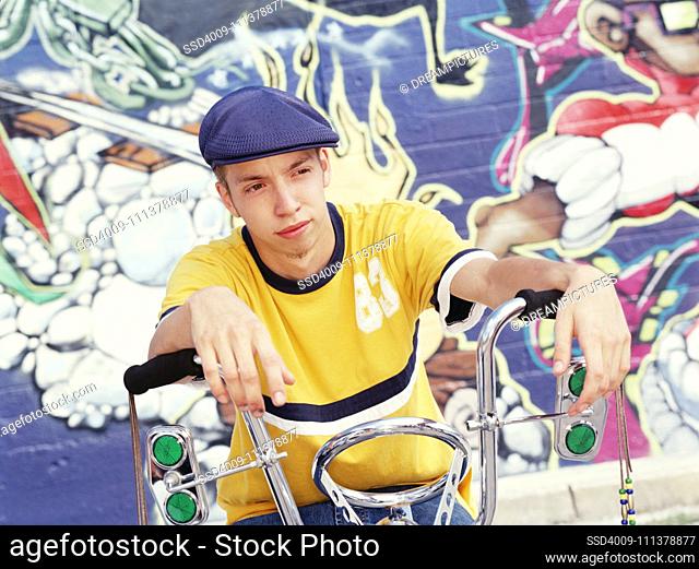 Teenage boy sitting on his bike