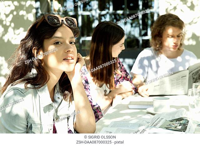 Young woman enjoying meal with friends outdoors