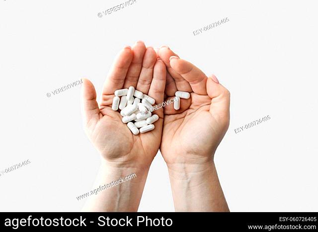 Many pills in female hands. Treatment healthcare concept