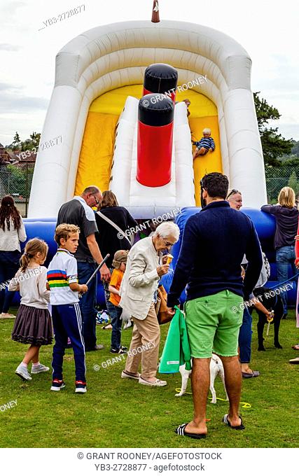 Children Playing On A Bouncy Castle At The Annual Hartfield Village Fete, Hartfield, East Sussex, UK