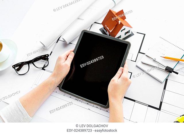 business, architecture, building, construction and people concept - close up of architect hand with living house blueprint and tablet pc computer