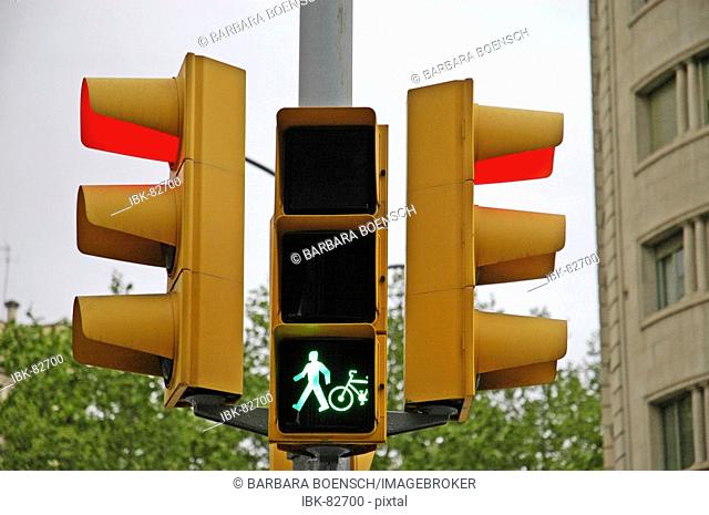 Traffic light, green light for pedestrians and cyclists, red light for the street traffic, Barcelona, Catalonia, Spain