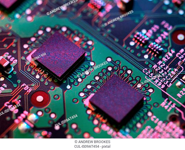 Close up detail of purple and green computer circuit board