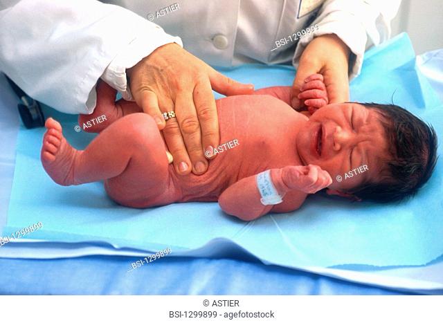 Diaconnesses: pediatry service. Pediatrician examining the abdomen of a 3-5 days old new born baby
