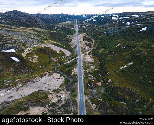 Russia, Murmansk Oblast, Teriberka, Aerial view of straight asphalt road across mountainous landscape