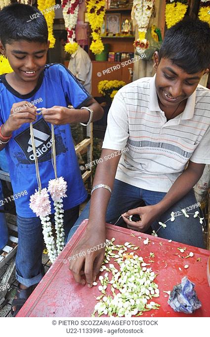 George Town, Penang (Malaysia): Indian (Tamil) boys making garlands with flowers by the Goddess of Mercy Chinese Temple
