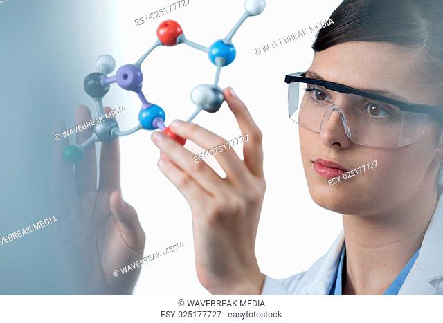 Female scientist holding molecular model
