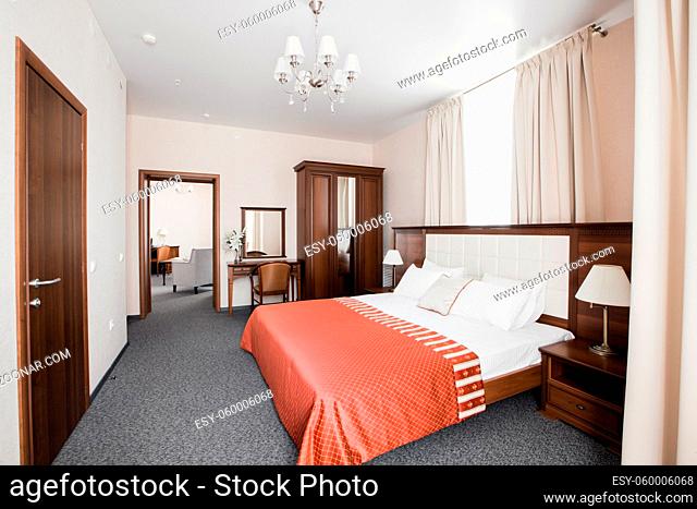 Hotel apartment, bedroom interior in the morning. two-room Suite, with large double bed