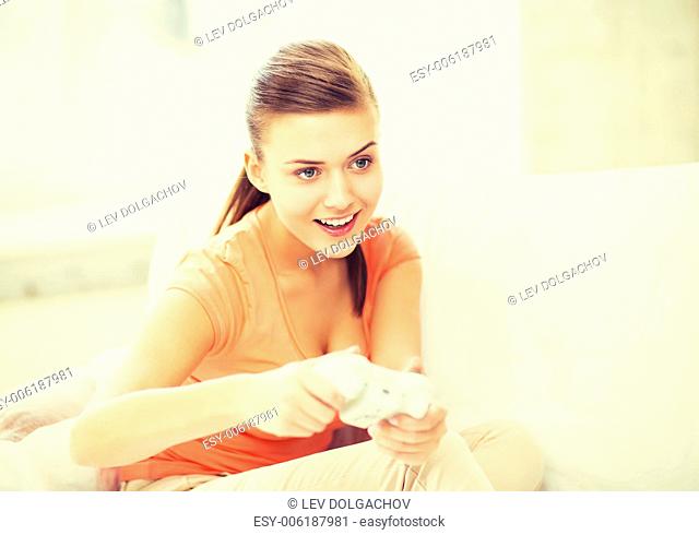 entertainment, home and internet - woman with joystick playing video games